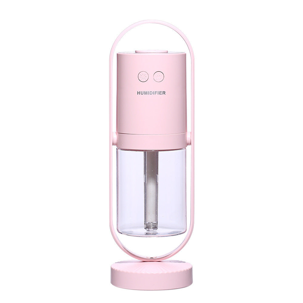 Pink USB ultrasonic air humidifier with transparent water tank and oval frame stand.