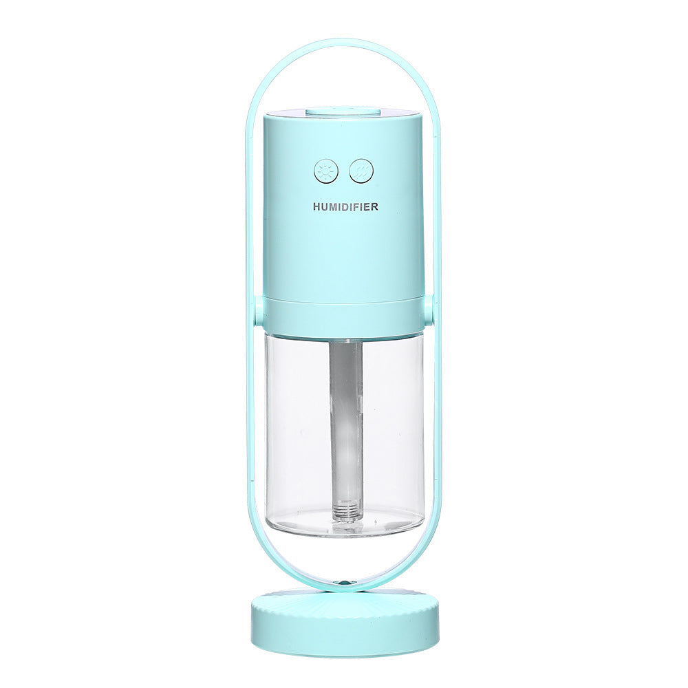 Light blue USB ultrasonic air humidifier with transparent water tank and handle.