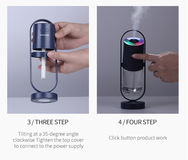 Dark blue USB air humidifier with transparent water tank, shown in use with colorful projection light and mist output.