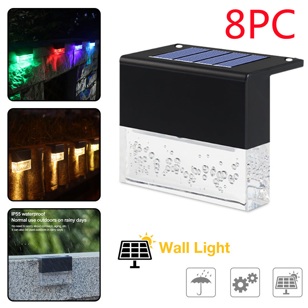 Black waterproof solar-powered LED step fence light with clear textured lens and built-in solar panel, shown in eight-piece.