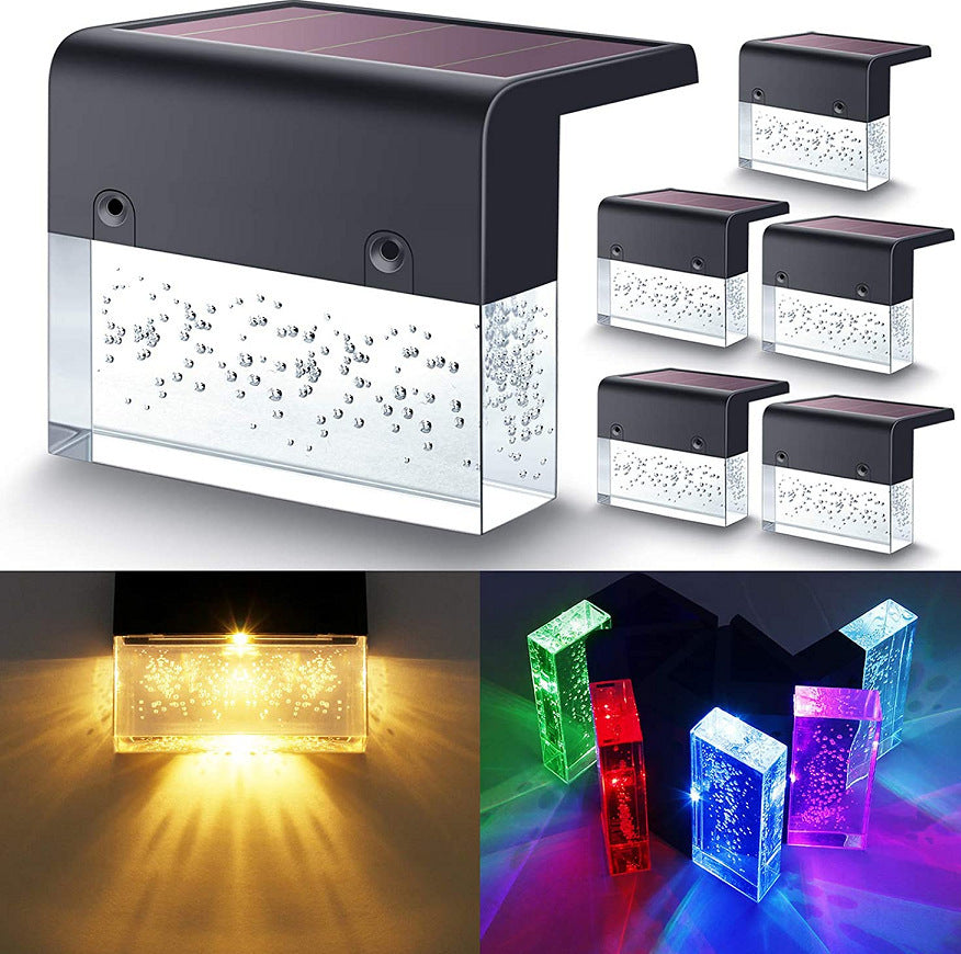 Black solar step light with bubble-textured clear panel and top solar panel, shown with warm white and multicolor RGB LED.