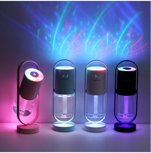 Four cordless USB air humidifiers in black, dark blue, gray, and black with projection night lights creating colorful starry .