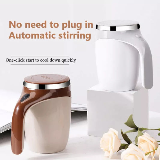White and brown electric automatic stirring cup with handle and silver rim on lid, placed on white blocks with beige roses.